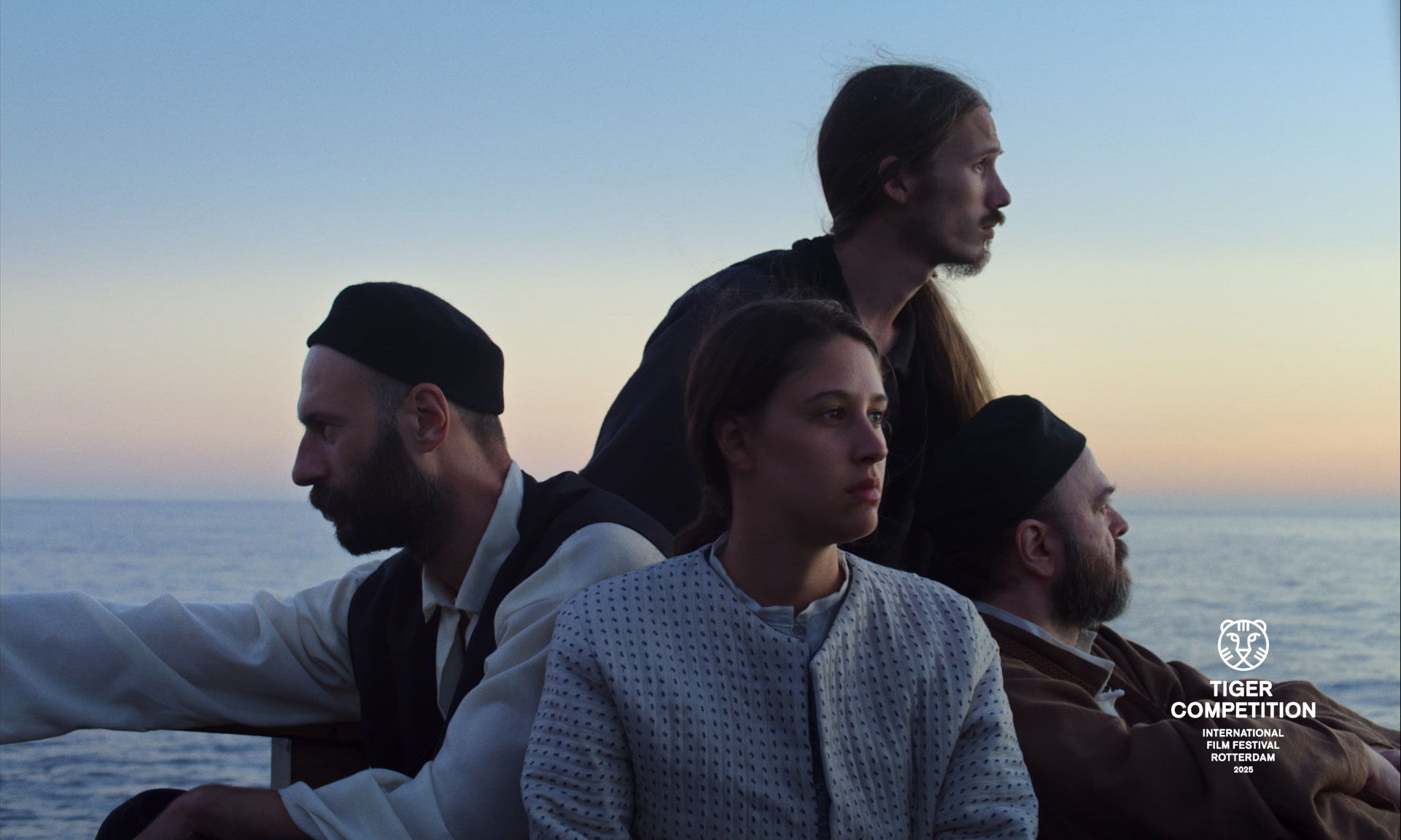 Four people sit closely on a boat at dusk, looking thoughtfully in different directions over the sea.